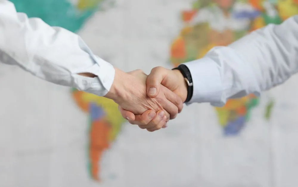Handshake over a world map